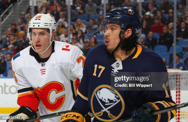 Michael Stone of the Calgary Flames and Jordan Nolan of the Buffalo Sabres follow the play during an NHL game on March 7, 2018 at KeyBank Center in...