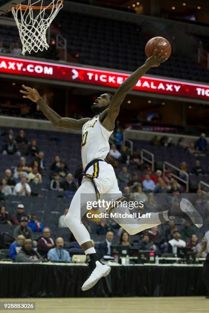 Johnson of the La Salle Explorers gets fouled and makes a basket against the Massachusetts Minutemen in the first round of the Atlantic 10 basketball...