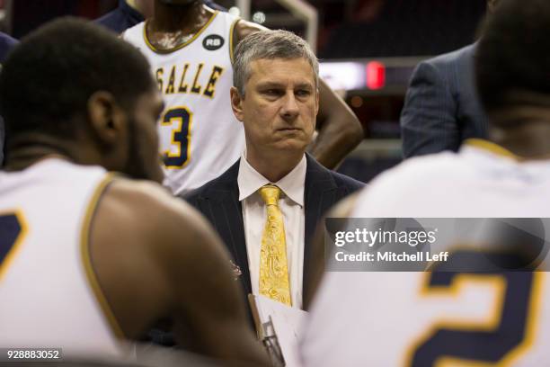 Head coach Dr. John Giannini of the La Salle Explorers talks to his team during a timeout against the Massachusetts Minutemen in the first round of...