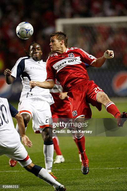 Brian McBride of the Chicago Fire and Shalrie Joseph the New England Revolution go for the ball during the first half of Game Two of the Eastern...