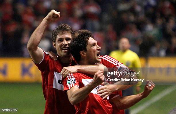 John Thorrington and Logan Pause of the Chicago Fire celebrate Thorrington's goal against the New England Revolution during the first half of Game...