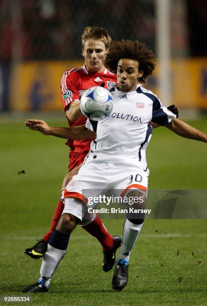 Chris Rolfe of the Chicago Fire tries toe get the ball away from Kevin Alston of the New England Revolution during the first half of Game Two of the...