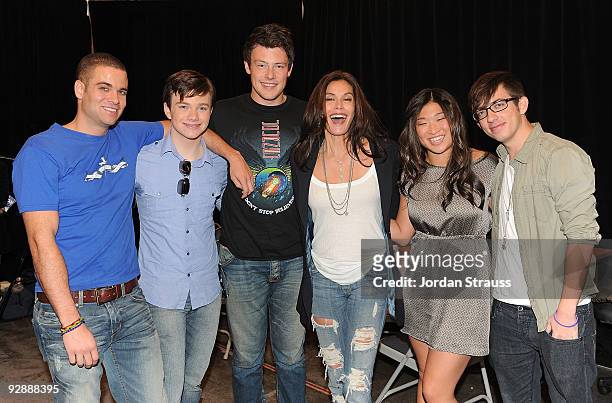 Actors Mark Salling, Chris Colfer, Cory Monteith, Teri Hatcher, Jenna Ushkowitz and Kevin McHale pose backstage as the cast of "Glee" signs copies of...