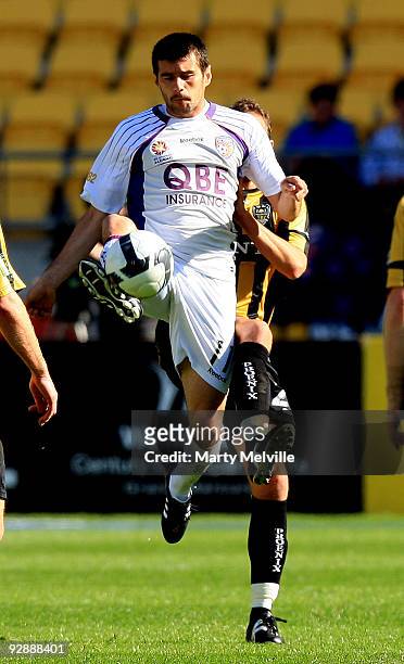 Branko Jelic of the Glory gets tackled by Tony Lochhead of the Phoenix during the round 14 A-League match between the Wellington Phoenix and the...
