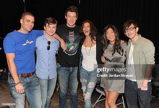 Actors Mark Salling, Chris Colfer, Cory Monteith, Teri Hatcher, Jenna Ushkowitz and Kevin McHale pose backstage as the cast of "Glee" signs copies of...