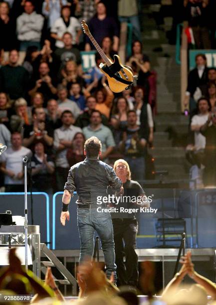 Bruce Springsteen throws his guitar during his performance onstage at Madison Square Garden on November 7, 2009 in New York City.