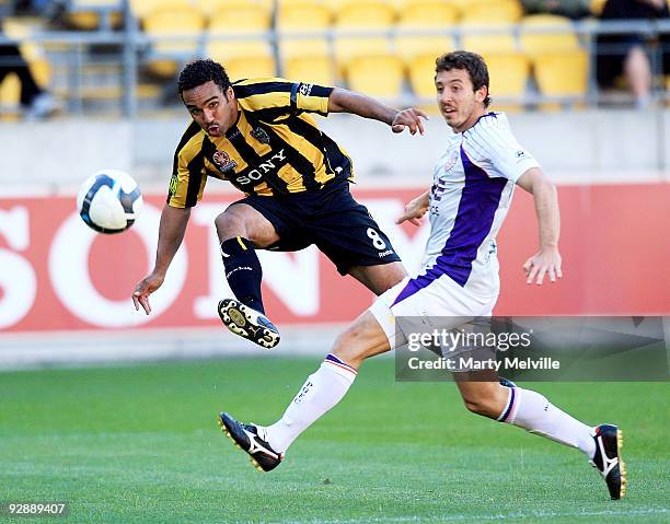 Paul Ifill of the Phoenix gets a pass away with Naum Sekulovski of the Glory in defence during the round 14 A-League match between the Wellington...