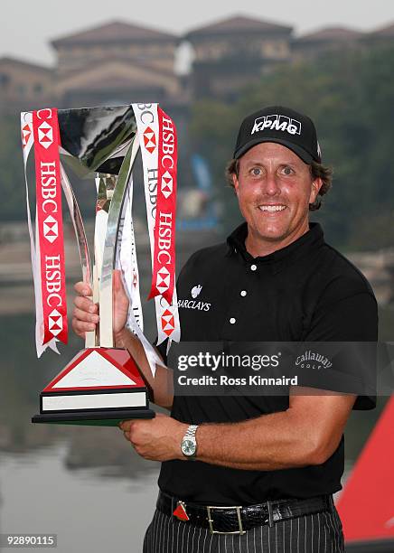 Phil Mickelson of the USA poses with the winners trophy after the final round of the WGC - HSBC Champions at Sheshan International Golf Club on...