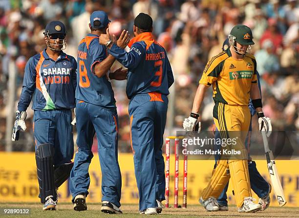 Harbhajan Singh of India is congratulated by his team mates after taking the wicket of Shane Watson of Australia during the sixth One Day...