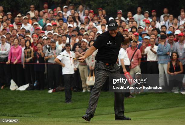 Phil Mickelson of the USA celebrates a par putt on the 16th green during the final round of the WGC-HSBC Champions at Sheshan International Golf Club...