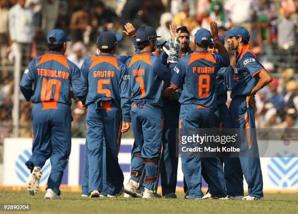Harbhajan Singh of India is congratulated by his team mates after taking the wicket of Ricky Ponting of Australia during the sixth One Day...