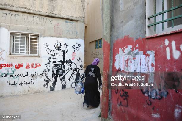 Mural painting and graffitis by Palestinian painter Aysar in the Palestinian refugee camp of Aida near Bethlehem on April 14, 2014 in Palestine.