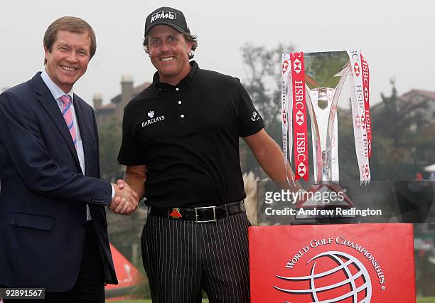 Phil Mickelson of the USA poses with the trophy alongside George O'Grady, Chief Executive of The European Tour, after his one-stroke victory at the...