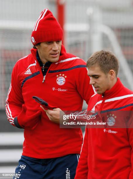 Philipp Lahm and Luca Toni chat during the Bayern Muenchen training session at Bayern's training ground 'Saebener Strasse' on November 8, 2009 in...