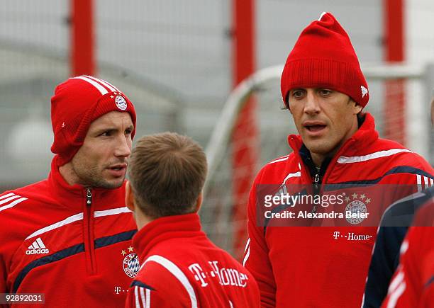 Mark van Bommel, Philipp Lahm and Luca Toni chat during the Bayern Muenchen training session at Bayern's training ground 'Saebener Strasse' on...