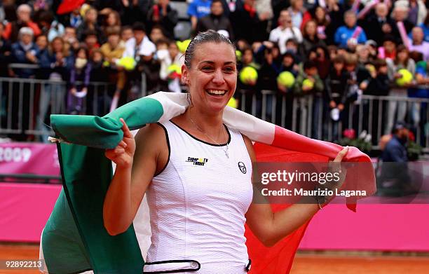 Flavia Pennetta of Italy celebrates a victory with her country flag after the Final of the Fed Cup World Group between Italy and the USA at Circolo...
