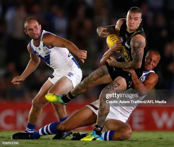 Dustin Martin of the Tigers is tackled by Braydon Preuss of the Kangaroos during the AFL 2018 JLT Community Series match between the Richmond Tigers...