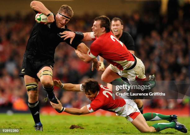 Brad Thorn of New Zealand breaks past Matthew Rees and Martin Roberts of Wales during the Invesco Perpetual Series Match between Wales and New...