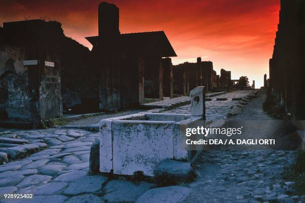 Sunset view of via dell'Abbondanza , lower decuman of Pompeii , Campania, Italy. Roman civilization, 1st century.