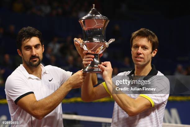 Nenad Zimonjic of Serbia and Daniel Nestor of Canada lift the winners trophy after defeating Mike and Bob Bryan of USA in the doubles final during...