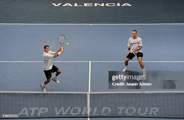 Frantisek Cermak of the Czech Republic smashes the ball flanked by his doubles partner Michal Mertinak of Slovakia to Marcel Granollers and Tommy...