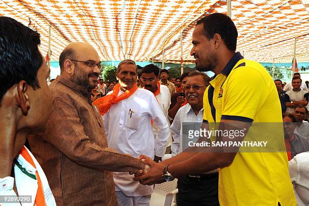 Indian cricketer Yusuf Pathan is greeted by Amit Shah, Vice President of the Gujarat Cricket Association and Minister of state for Home, Law and...