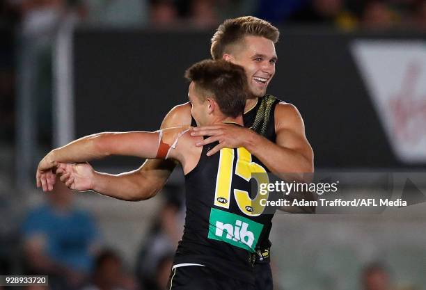 Dan Butler of the Tigers celebrates a goal with Jayden Short of the Tigers during the AFL 2018 JLT Community Series match between the Richmond Tigers...