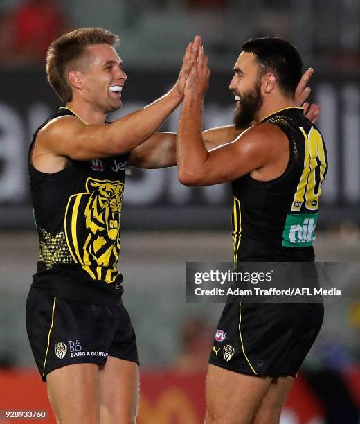 Dan Butler of the Tigers celebrates a goal with Shane Edwards of the Tigers during the AFL 2018 JLT Community Series match between the Richmond...