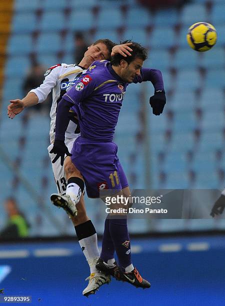 Andrea Coda of Udinese Calcio competes in the air with Alberto Gilardino of ACF Fiorentina during the Serie A match between Udinese Calcio and ACF...