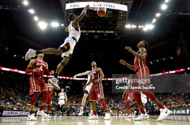 Cameron McGriff of the Oklahoma State Cowboys dunks during the first round of the Big 12 Basketball Tournament against the Oklahoma Sooners at the...