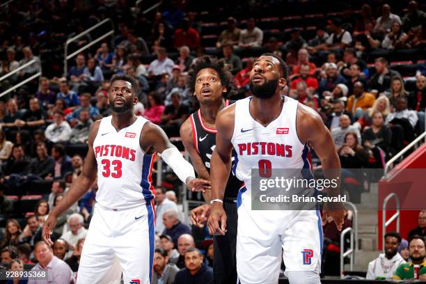 Andre Drummond of the Detroit Pistons and James Ennis III of the Detroit Pistons play defense against Lucas Nogueira of the Toronto Raptors on March...