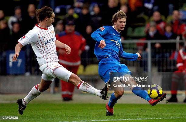 Michael Blum of Karlsruhe is challenged by Bernd Rauw of Berlin during the Second Bundesliga match between Karsruher SC and Union Berlin at the...