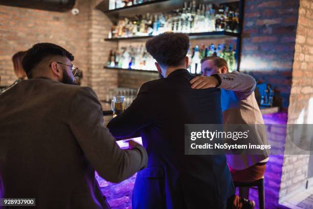two man comforting a friend who has emotional problems - best friends night out men only candid stock pictures, royalty-free photos & images