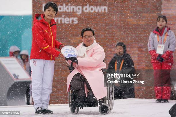 Chinese athletes and village mayor Park Eun-Soo attend a welcome ceremony at the PyeongChang Olympic Village ahead of the PyeongChang 2018 Paralympic...
