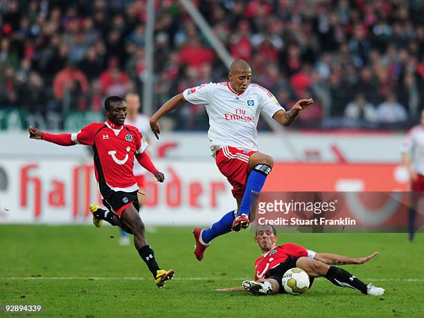 Djakpa Constant and Pinto Da Silva of Hannover 96 challenge Jerome Boateng of Hamburg during the Bundesliga match between Hannover 96 and Hamburger...