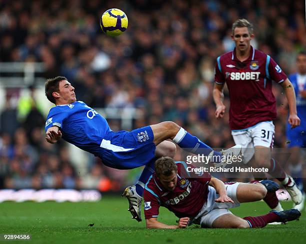 Jonathan Spector of West Ham tackles Dan Gosling of Everton during the Barclays Premier League match between West Ham United and Everton at Upton...