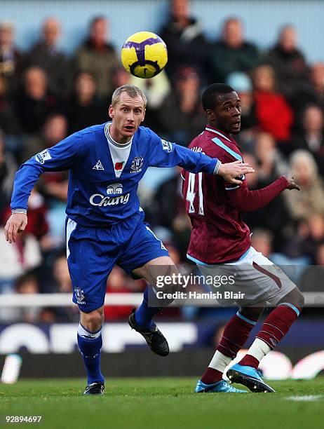 Zavon Hines of West Ham battles for the ball with Tony Hibbert of Everton during the Barclays Premier League match between West Ham United and...