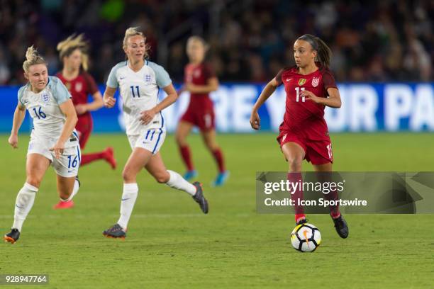 United States forward Mallory Pugh looks for options as she is pursued by England midfielder Izzy Christiansen and England forward Toni Duggan during...