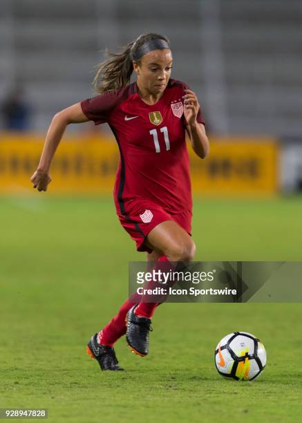 United States forward Mallory Pugh looks to dribble past an opponent during the first half of the SheBelieves Cup match between USA and England on...