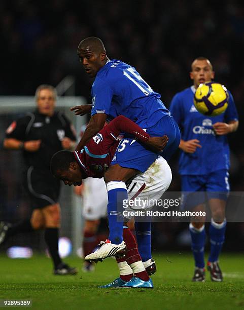 Sylvain Distin of Everton rides on the back of Zavon Hines of West Ham during the Barclays Premier League match between West Ham United and Everton...