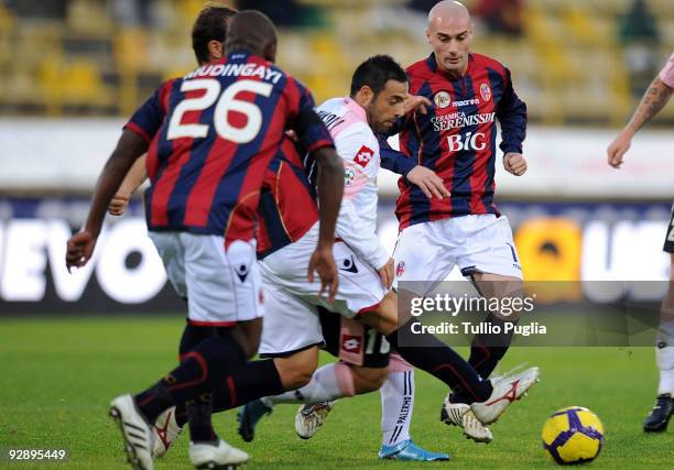 Fabrizio Miccoli of Palermo is challenged by Gaby Mudingayi and Roberto Guana during the Serie A match between Bologna FC and US Citta di Palermo at...