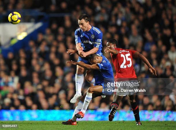John Terry and Ashley Cole of Chelsea collide with Antonio Valencia of Manchester United during the Barclays Premier League match between Chelsea and...
