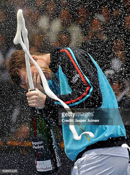 Andy Murray of Great Britain covers his eyes after he sprayed champagne in it celebrating his win over Mikhail Youzhny of Russia in the final of the...