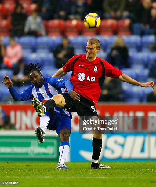 Jason Scotland of Wigan Athletic and Brede Hangeland of Fulham head for the ball during the Barclays Premier League match between Wigan Athletic and...