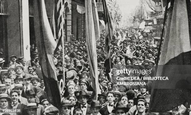 People celebrating Italian victory in First World War in Buenos Aires, Argentina, in front of the daily La Nacion's headquarters, from the magazine...