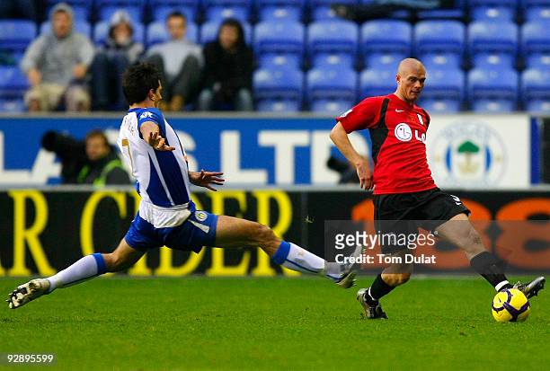 Paul Scharner of Wigan Athletic and Paul Konchesky of Fulham battle for the ball during the Barclays Premier League match between Wigan Athletic and...