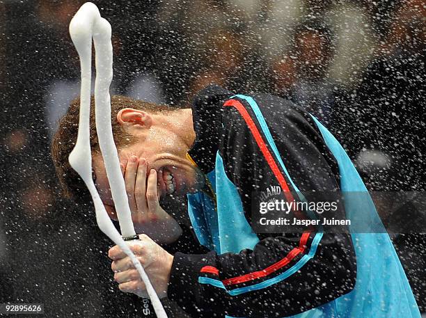 Andy Murray of Great Britain covers his eyes after he sprayed champagne celebrating his win over Mikhail Youzhny of Russia in the final of the ATP...