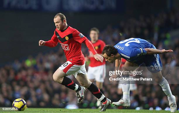 Wayne Rooney of Manchester United in breaks past John Terry of Chelsea during the FA Barclays Premier League match between Chelsea and Manchester...