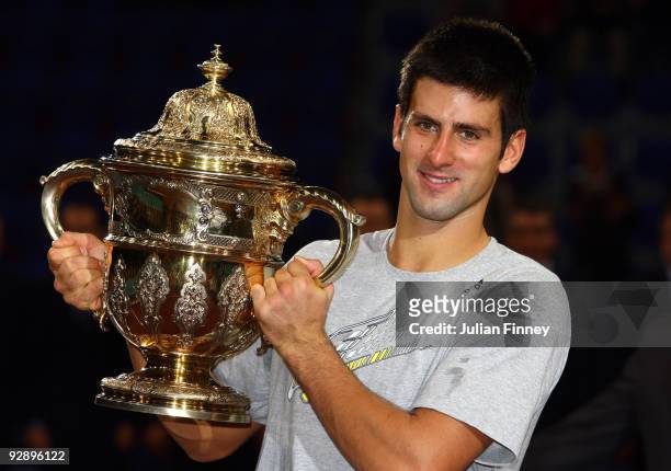 Novak Djokovic of Serbia celebrates with the trophy after defeating Roger Federer of Switzerland in the final during Day Seven of the Davidoff Swiss...