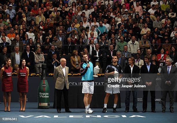 Andy Murray of Great Britain talks to the crowd as he holds up the winners trophy flanked by Mikhail Youzhny of Russia during the price giving...